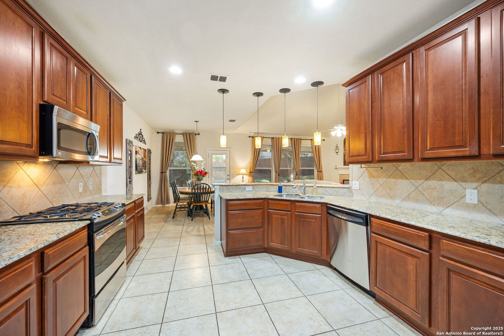 8206 Setting Moon San Antonio, TX 78255 - Photo 7 of 36 a kitchen with stainless steel appliances granite countertop a stove top oven a sink dishwasher and cabinets with granite countertops