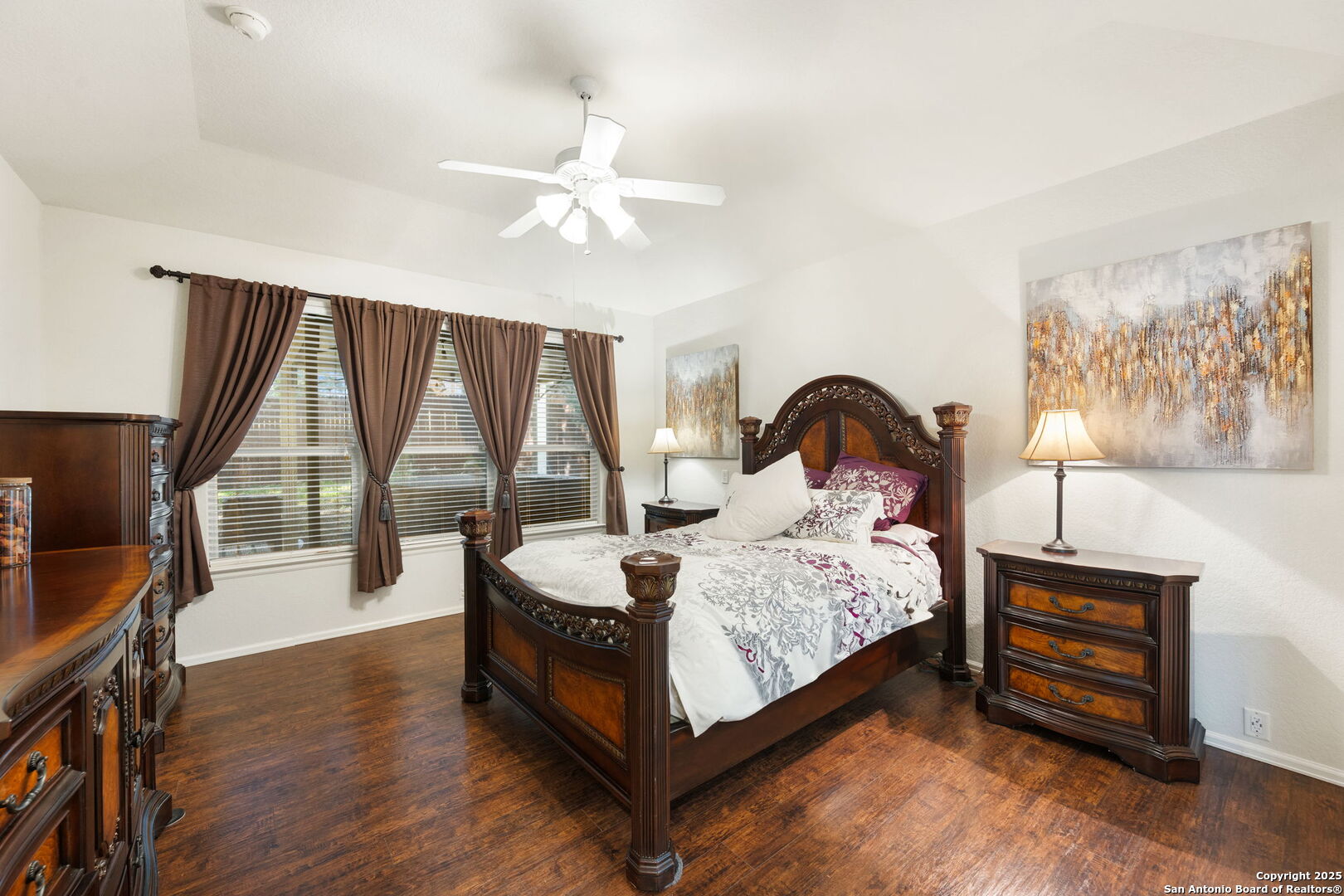 8206 Setting Moon San Antonio, TX 78255 - Photo 9 of 36 a bedroom with a bed lamp and a large window with wooden floor
