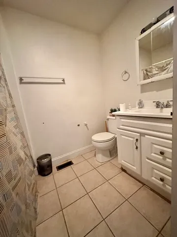 a bathroom with a toilet a sink and a mirror