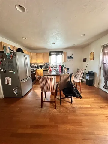 a living room with furniture a air conditioner vent and a window