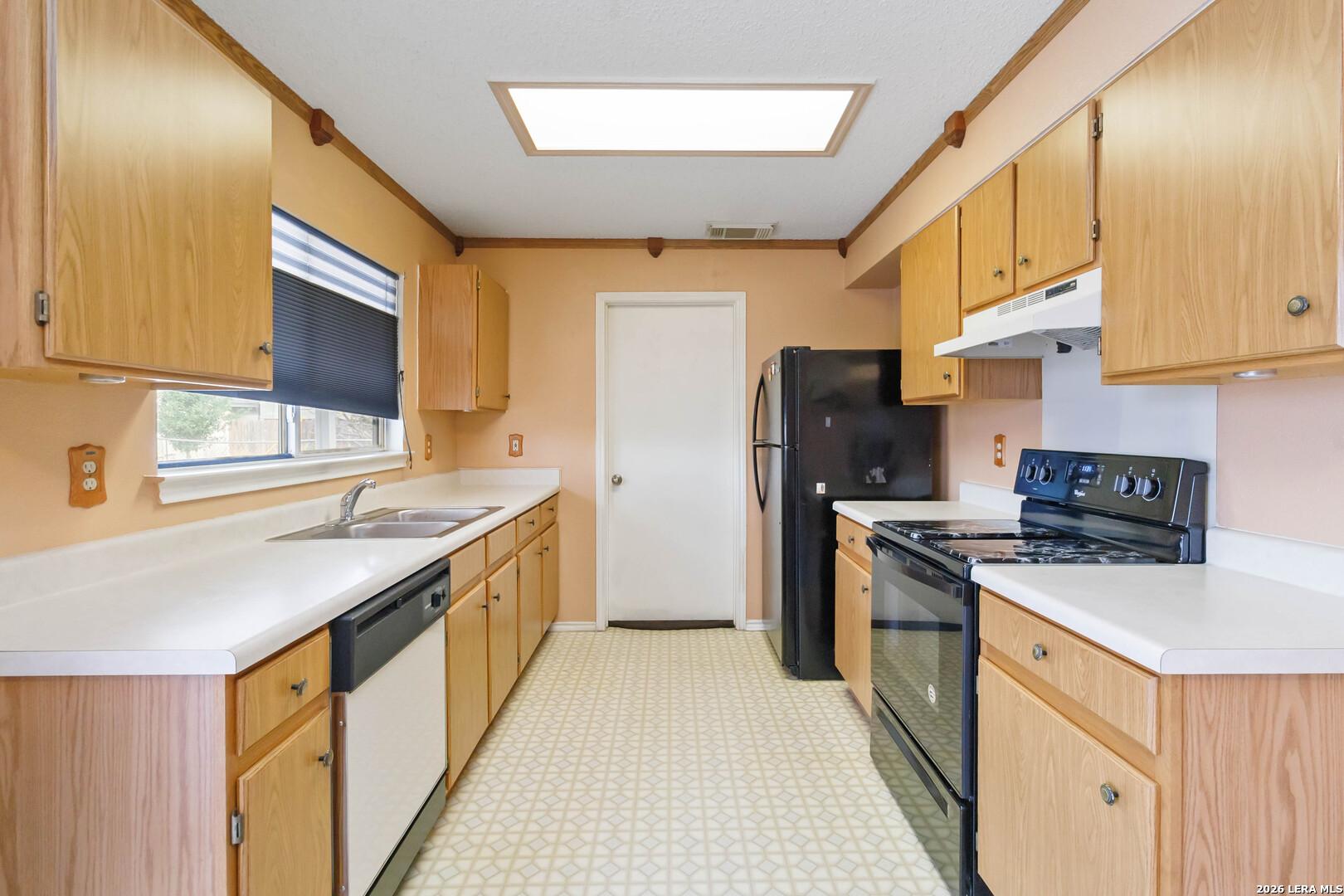 423 Rosa Verde San Antonio, TX 78207 - Photo 4 of 12 a kitchen with stainless steel appliances granite countertop a sink stove and refrigerator