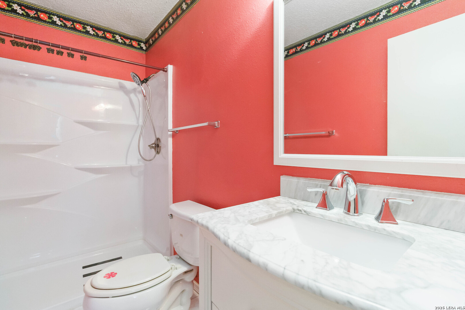 423 Rosa Verde San Antonio, TX 78207 - Photo 6 of 12 a bathroom with a sink a toilet and shower