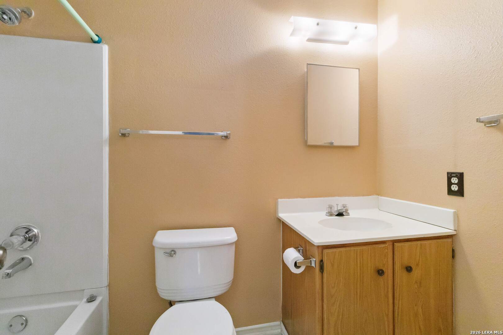 423 Rosa Verde San Antonio, TX 78207 - Photo 7 of 12 a bathroom with a sink a toilet and a mirror
