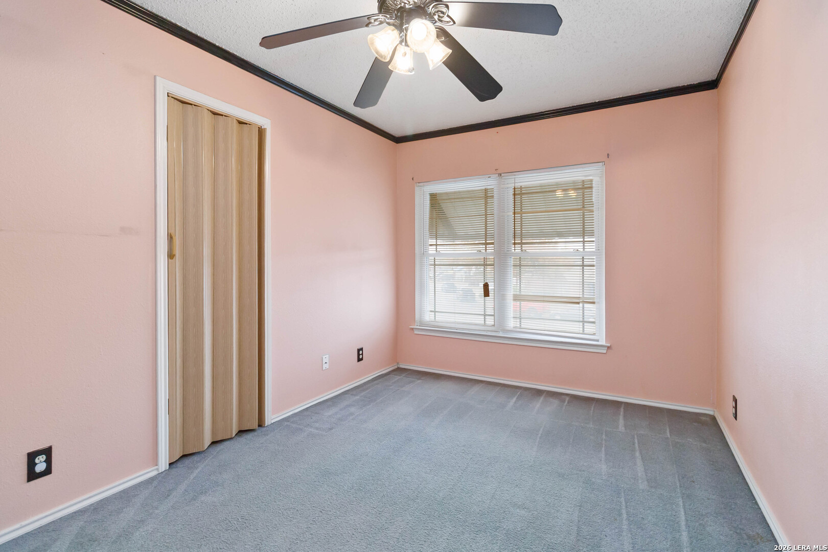 423 Rosa Verde San Antonio, TX 78207 - Photo 9 of 12 an empty room with a window and a chandelier fan
