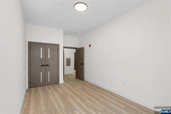a view of a room with wooden floor and bathroom