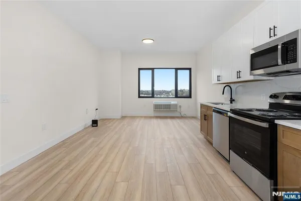 a kitchen with granite countertop a stove top oven and sink