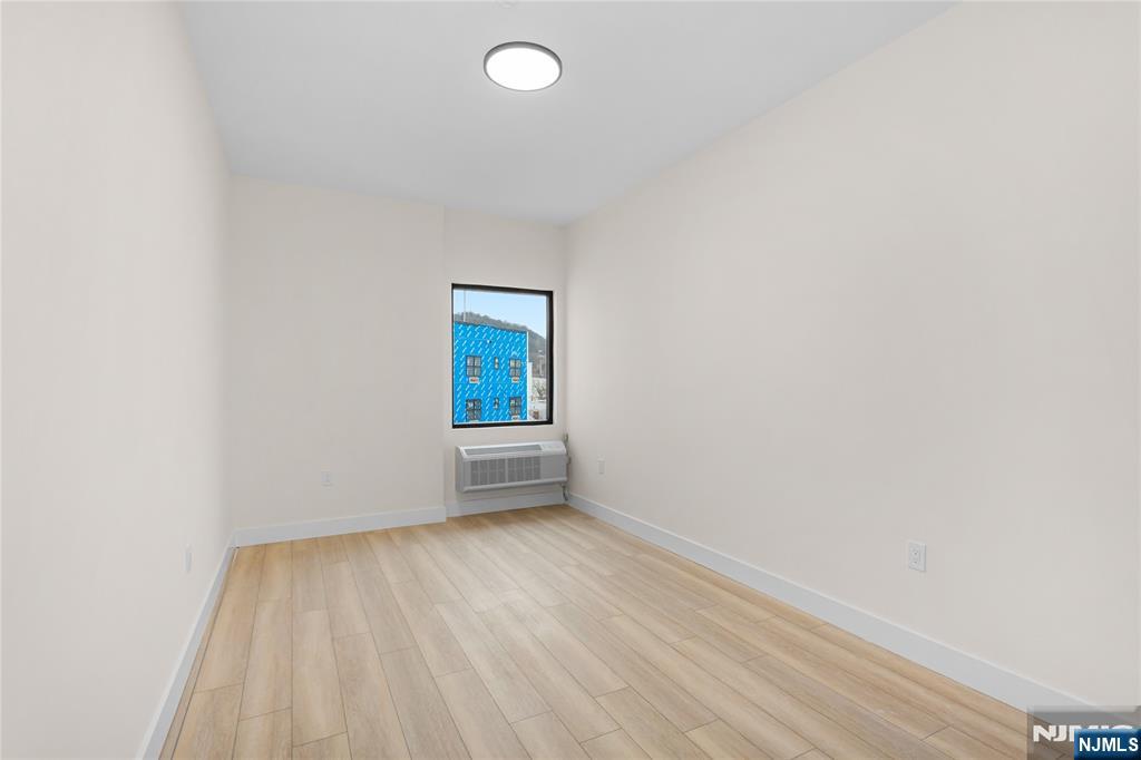 89 Mary Street, Unit 503 Paterson, NJ 07503 - Photo 10 of 14 a view of an empty room and window