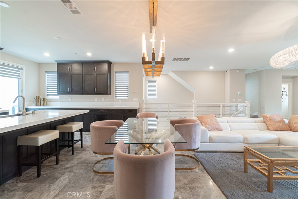 185 Tribeca Irvine, CA 92612 - Photo 11 of 55 a living room with furniture and a large window