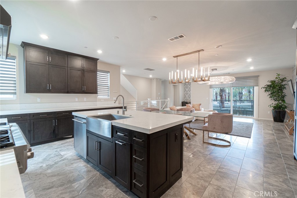 185 Tribeca Irvine, CA 92612 - Photo 12 of 55 a kitchen with a stove a counter top space and cabinets