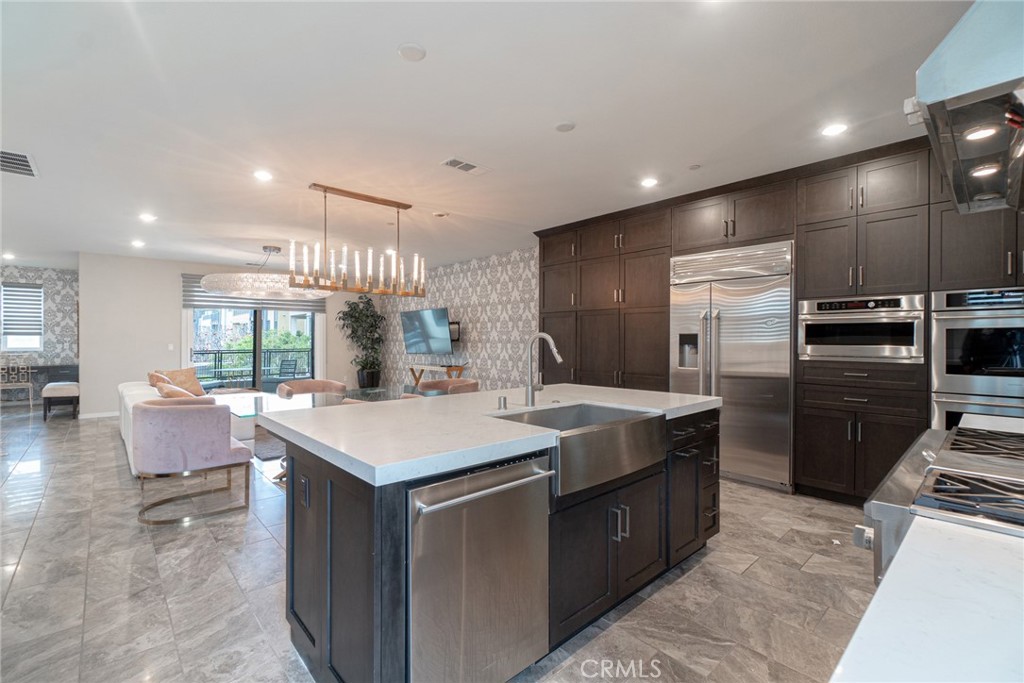 185 Tribeca Irvine, CA 92612 - Photo 13 of 55 a large kitchen with kitchen island a large island in it