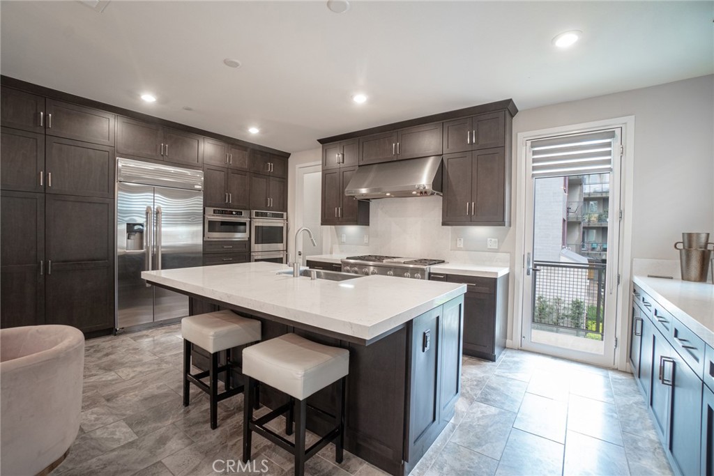185 Tribeca Irvine, CA 92612 - Photo 14 of 55 a kitchen with counter top space cabinets and stainless steel appliances