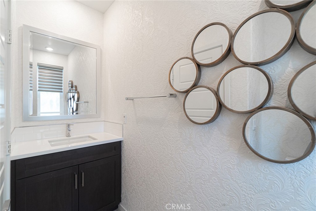 185 Tribeca Irvine, CA 92612 - Photo 17 of 55 a bathroom with a sink and a mirror