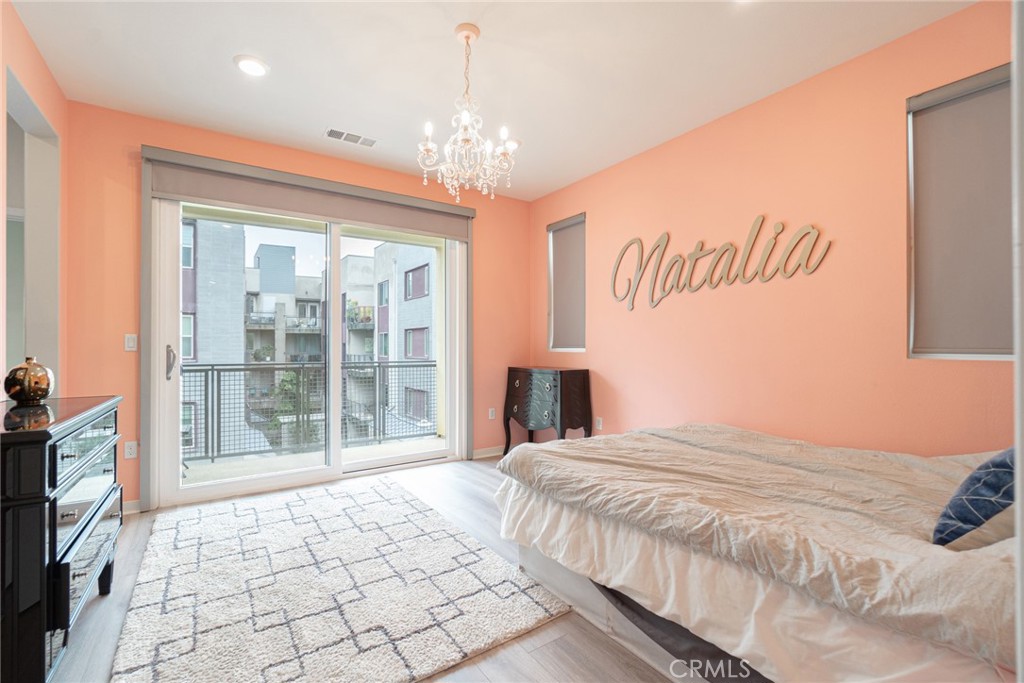 185 Tribeca Irvine, CA 92612 - Photo 20 of 55 a spacious bedroom with a bed and a window