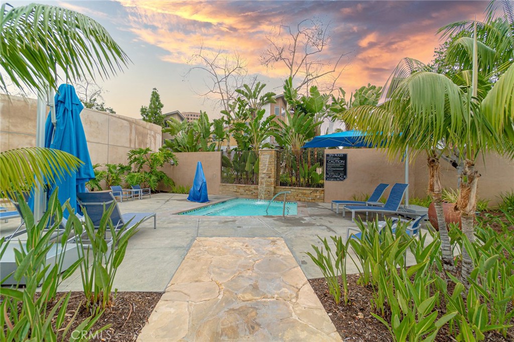 185 Tribeca Irvine, CA 92612 - Photo 53 of 55 a view of a yard with plants and a lawn chairs