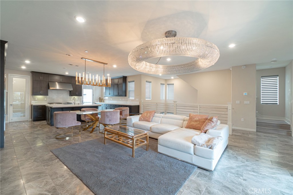 185 Tribeca Irvine, CA 92612 - Photo 6 of 55 a living room with furniture and kitchen view