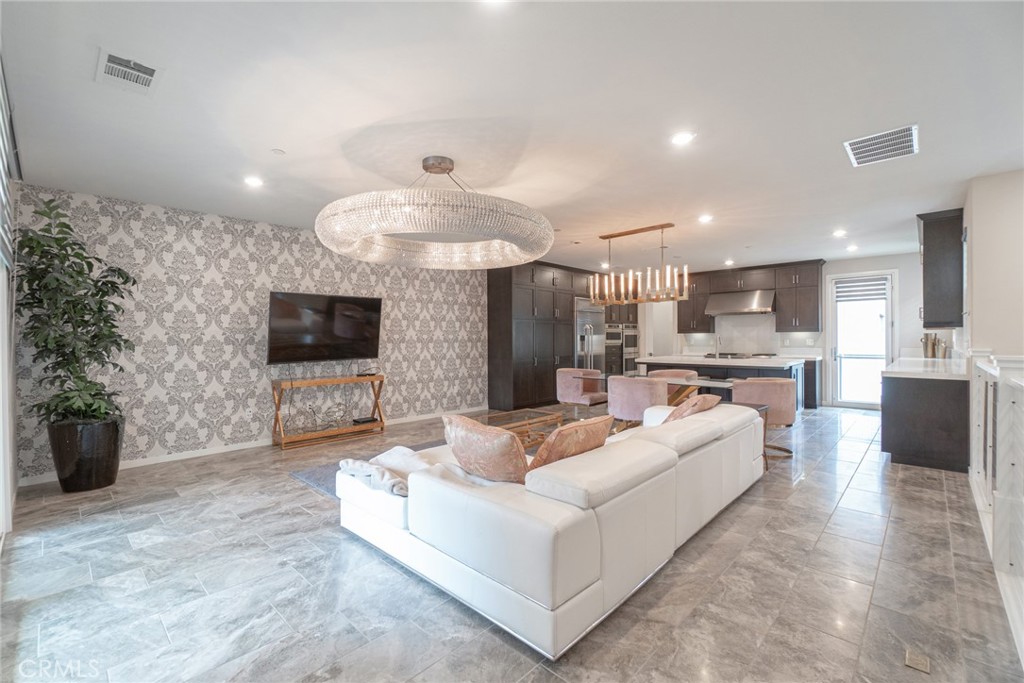 185 Tribeca Irvine, CA 92612 - Photo 7 of 55 a living room with furniture and a flat screen tv