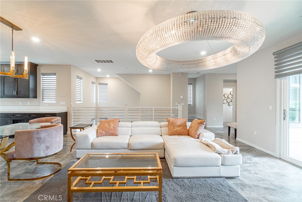 185 Tribeca Irvine, CA 92612 - Photo 8 of 55 a living room with furniture and a dining table