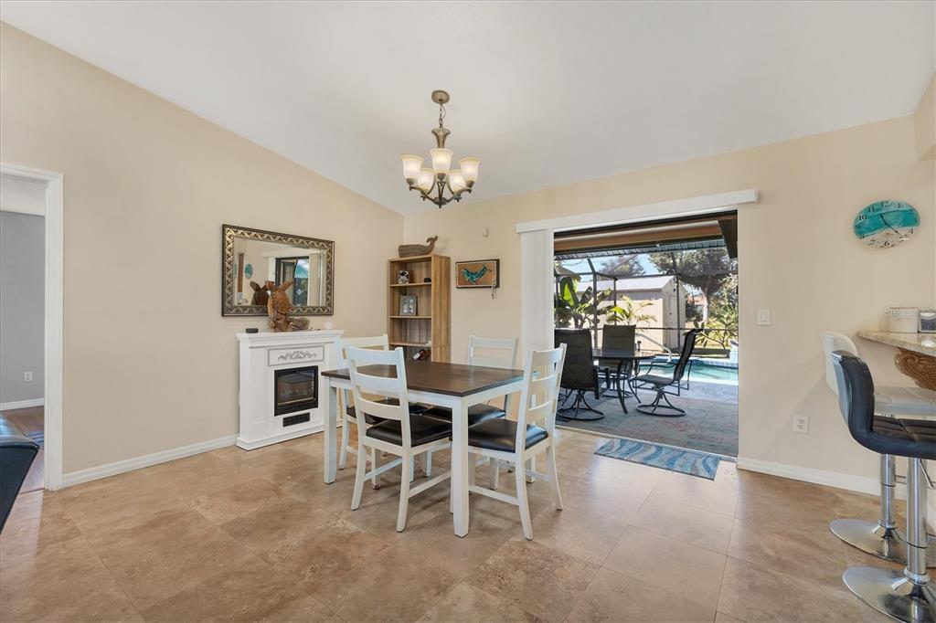 7047 Adderly Road Englewood, FL 34224 - Photo 14 of 39 a view of a dining room with furniture window and wooden floor