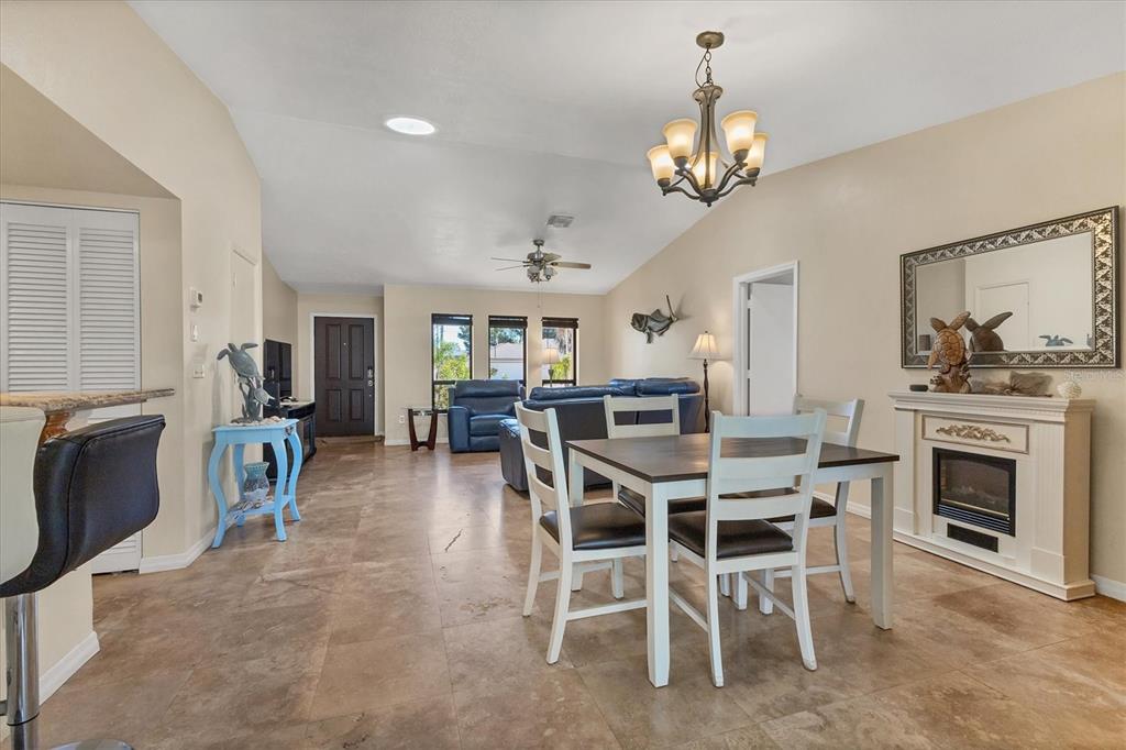7047 Adderly Road Englewood, FL 34224 - Photo 16 of 39 a view of a dining room with furniture and chandelier