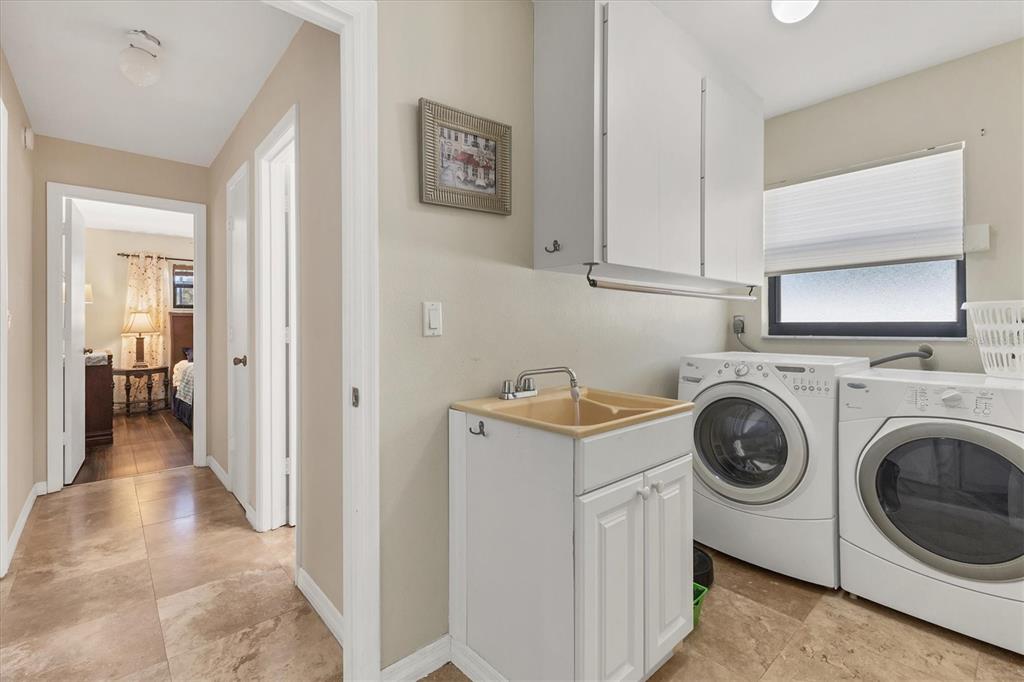 7047 Adderly Road Englewood, FL 34224 - Photo 22 of 39 a view of a storage and utility room with washer and dryer