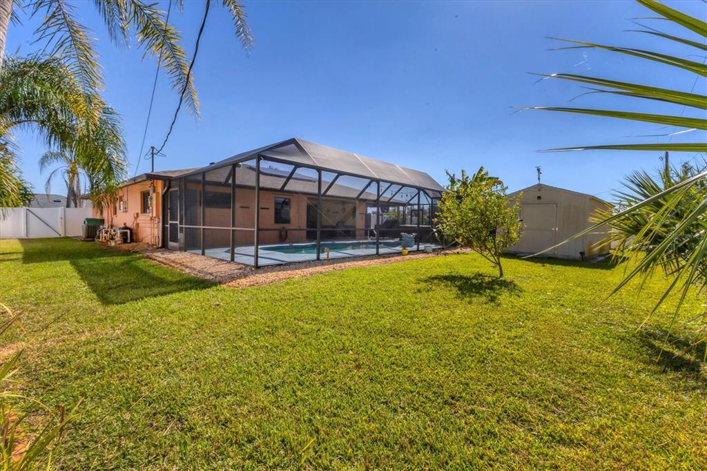 7047 Adderly Road Englewood, FL 34224 - Photo 31 of 39 a view of a house with a yard