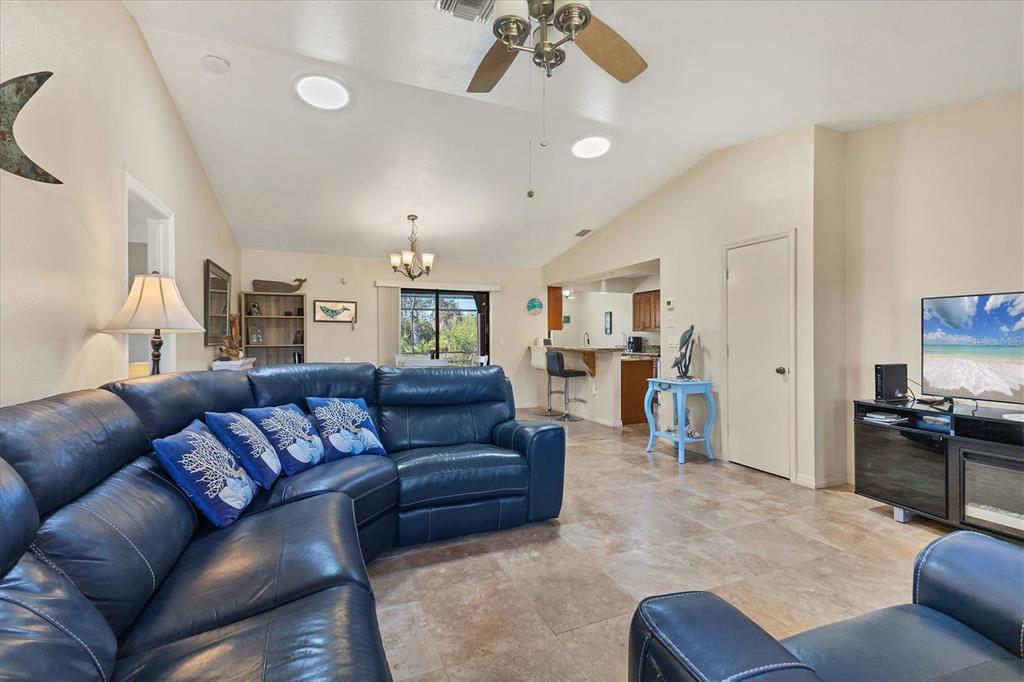 7047 Adderly Road Englewood, FL 34224 - Photo 6 of 39 a living room with furniture and a flat screen tv