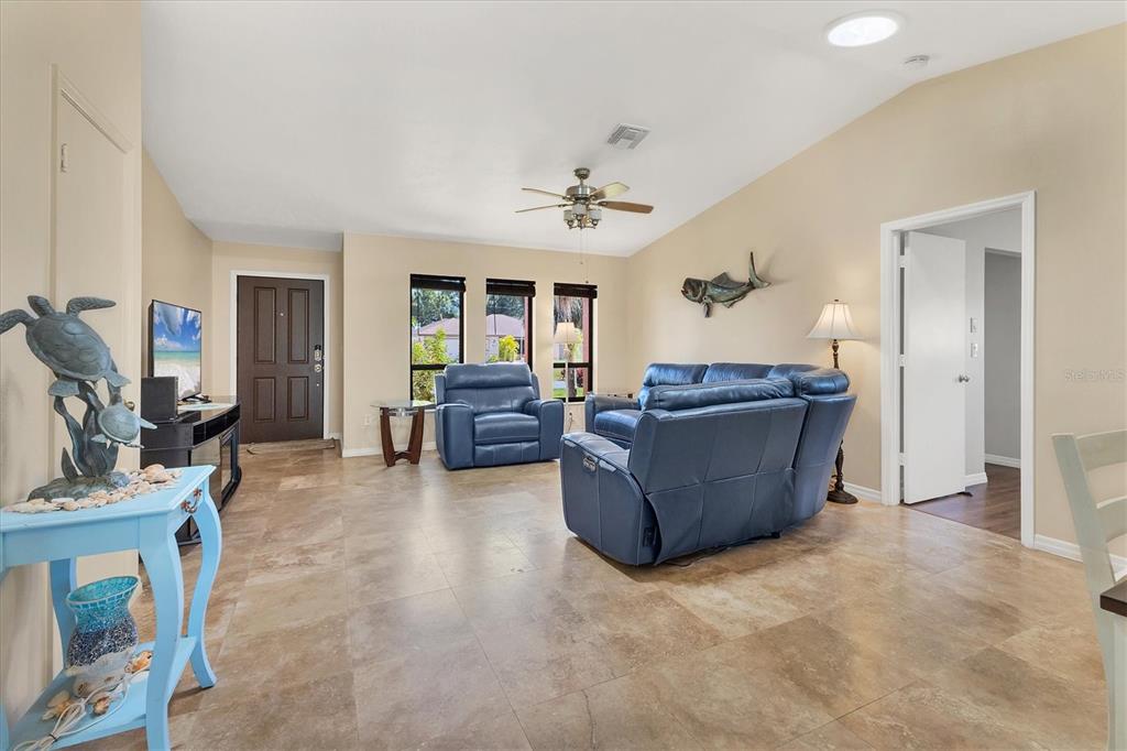 7047 Adderly Road Englewood, FL 34224 - Photo 7 of 39 a living room with furniture and a flat screen tv