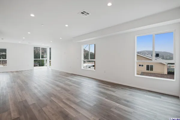 a large kitchen with stainless steel appliances granite countertop a stove a sink and a refrigerator