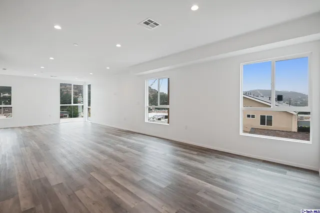 a large kitchen with stainless steel appliances granite countertop a stove a sink and a refrigerator