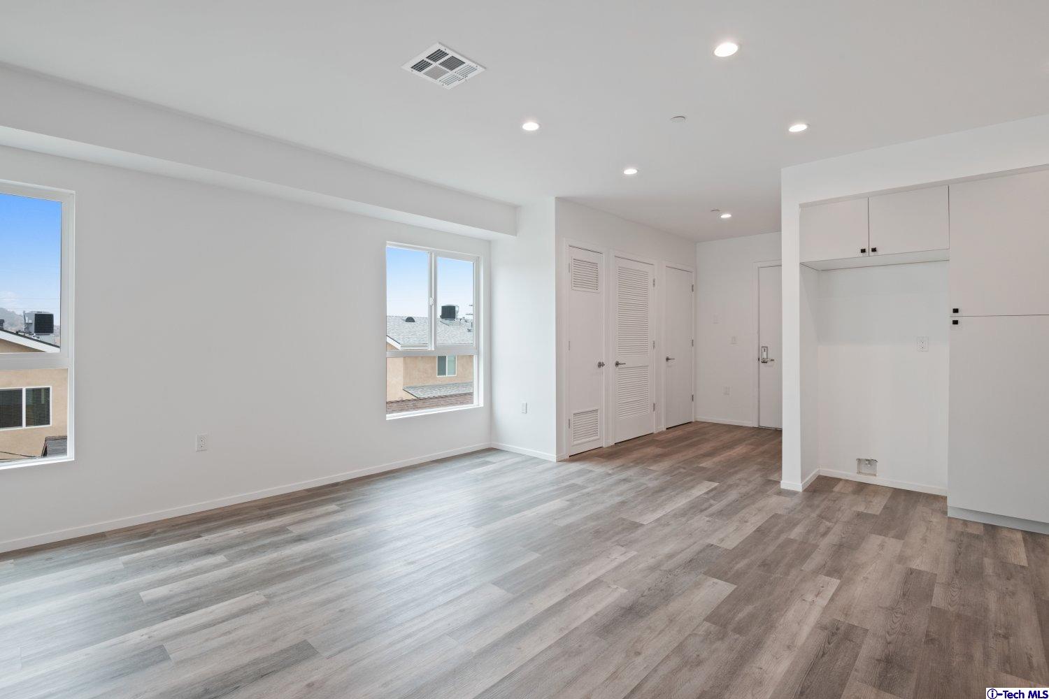 7064 Greeley Street, Unit 105 Tujunga, CA 91042 - Photo 21 of 46 a view of an empty room with wooden floor