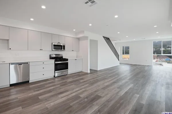 a view of a hallway with washer and dryer