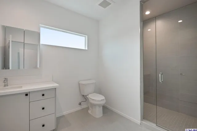 a view of an empty room with wooden floor and closet