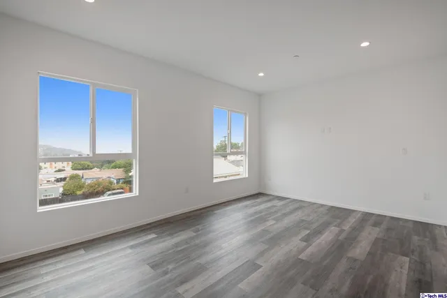 a bathroom with a toilet sink vanity and mirror
