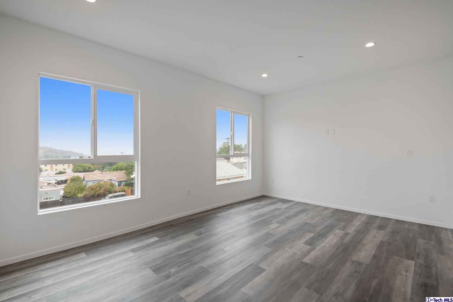 7064 Greeley Street, Unit 105 Tujunga, CA 91042 - Photo 37 of 46 a view of an empty room window and wooden floor