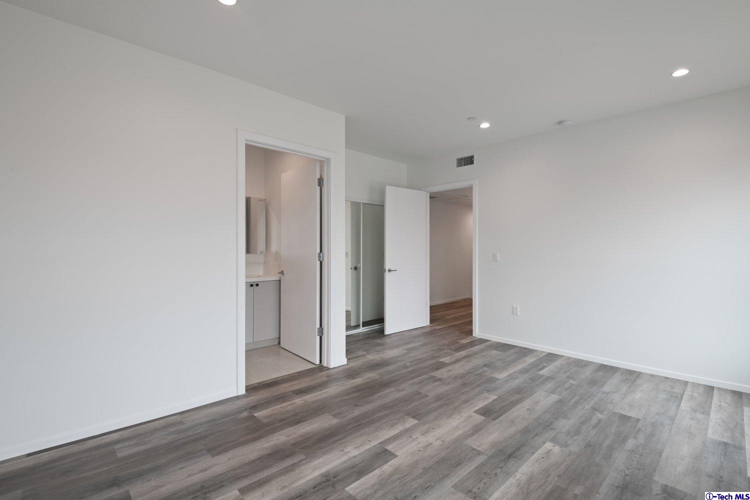 7064 Greeley Street, Unit 105 Tujunga, CA 91042 - Photo 39 of 46 a view of an empty room with wooden floor and closet