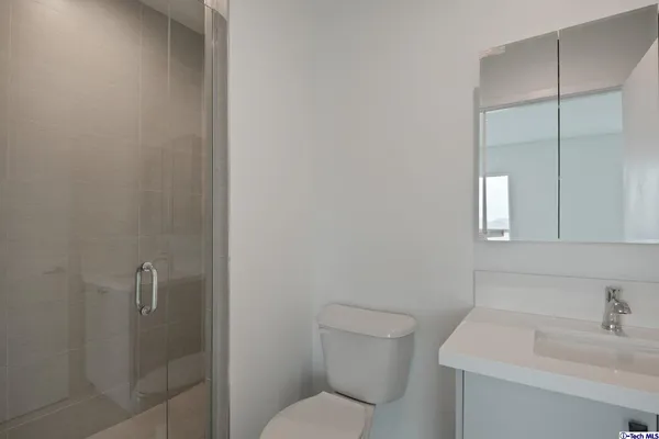 a view of a house with a yard and potted plants