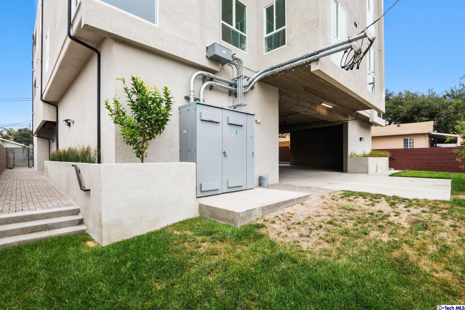 7064 Greeley Street, Unit 105 Tujunga, CA 91042 - Photo 43 of 46 a view of a house with a yard and potted plants