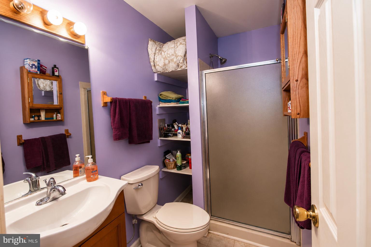 8121 Elizabeth Road Pasadena, MD 21122 - Photo 11 of 27 a bathroom with a sink toilet and shower