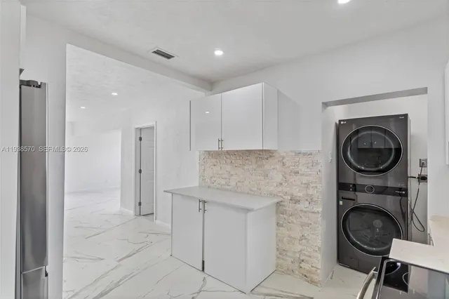 a kitchen with stainless steel appliances a refrigerator sink and microwave