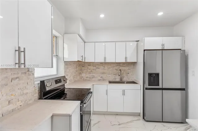 a bathroom with a granite countertop toilet a sink and a mirror