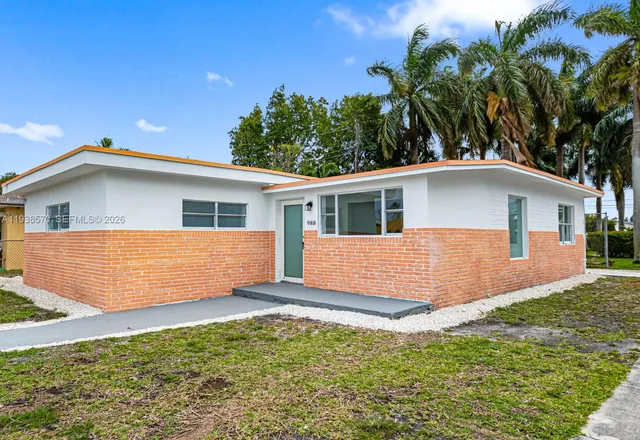 a view of house with backyard