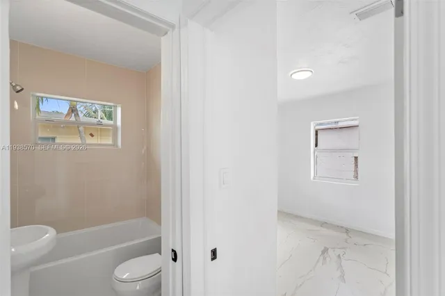 a bathroom with a sink toilet and a mirror