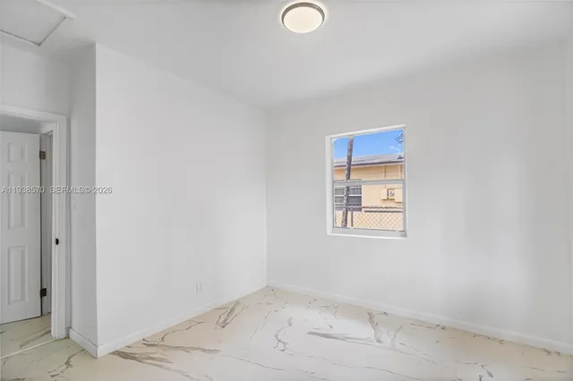 a view of a hallway with bathroom and a bathroom