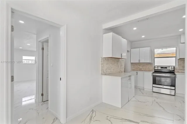 a kitchen with a stove a refrigerator and a sink