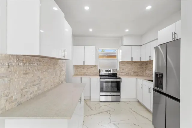 a view of a kitchen with washer and dryer