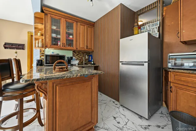 a kitchen with stainless steel appliances granite countertop a refrigerator a stove a sink and dishwasher