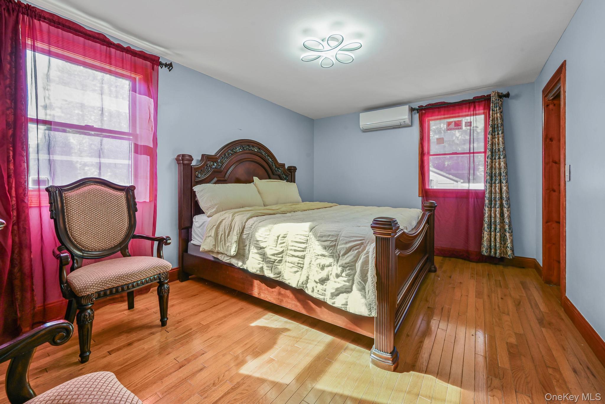 49 Ashley Drive Valley Stream, NY 11580 - Photo 13 of 29 a bedroom with a bed and wooden floor