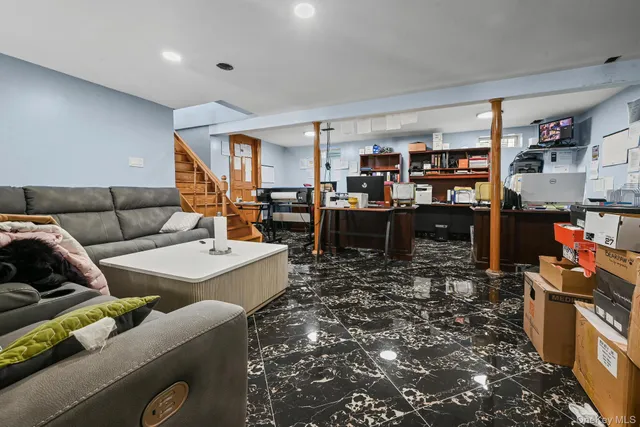 a living room with furniture and a book shelf