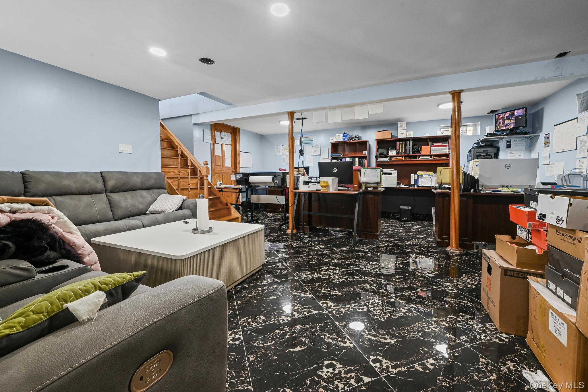 49 Ashley Drive Valley Stream, NY 11580 - Photo 18 of 29 a living room with furniture and a book shelf