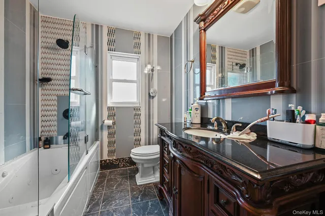 a bath room with a sink a toilet and shower
